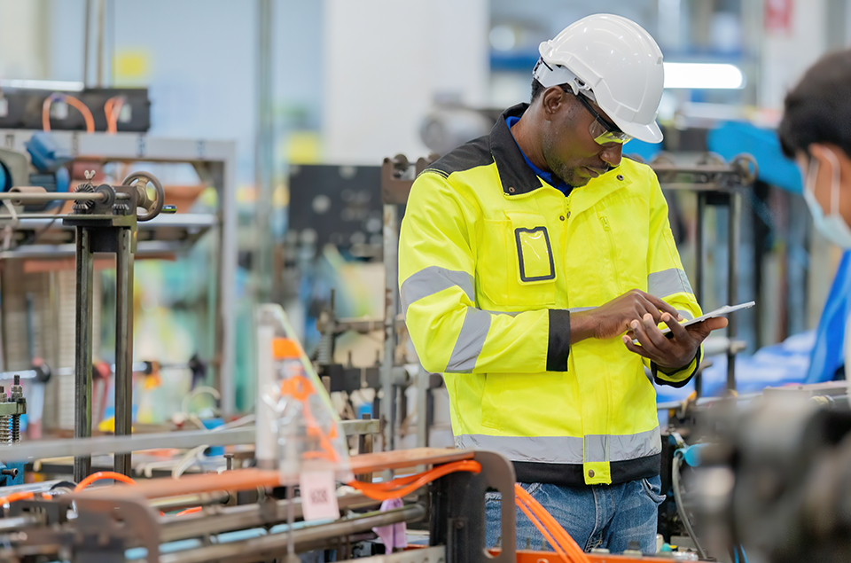 Grinding Wheel Balancer Engineer Looking at Tablet for Dressing & Balancing Grinding Wheels Work